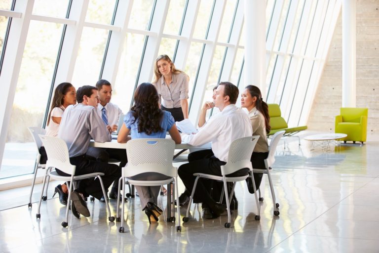 Meeting - people sitting in chairs around a table